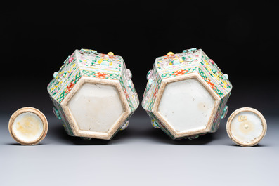 A pair of Chinese famille rose 'Antiquities' vases and covers, 19th C.