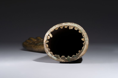 A rare and large Tibetan bronze forearm of a Buddhist figure with a chakra design, on a later metal stand, Qing