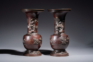 A pair of Japanese bronze vases with relief design of birds among flowering branches, signed Hasegawa Harusada 長谷川晴定, 19th C.