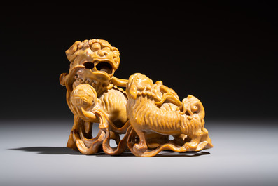 A fine Chinese soapstone group of Buddhist lions on wooden stand, 19th C.