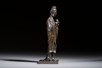 A Chinese bronze standing Guanyin with boy, Ming