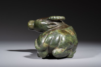 A Chinese green jade reclining buffalo on a wooden stand, 19/20th C.