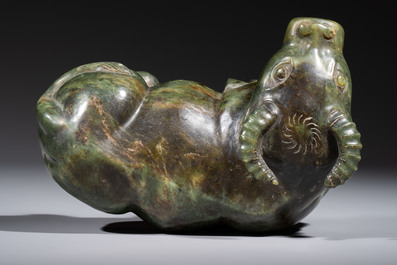 A Chinese green jade reclining buffalo on a wooden stand, 19/20th C.