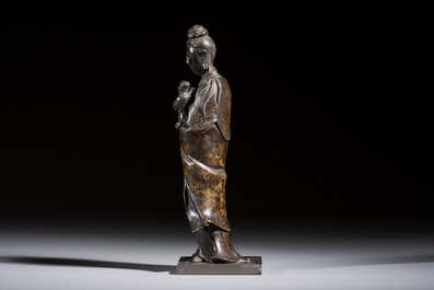 A Chinese bronze standing Guanyin with boy, Ming