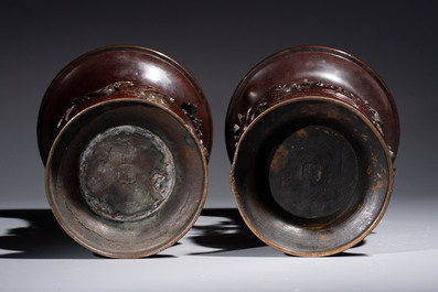 A pair of Japanese bronze vases with relief design of birds among flowering branches, signed Hasegawa Harusada 長谷川晴定, 19th C.