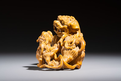 A fine Chinese soapstone group of Buddhist lions on wooden stand, 19th C.