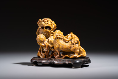 A fine Chinese soapstone group of Buddhist lions on wooden stand, 19th C.