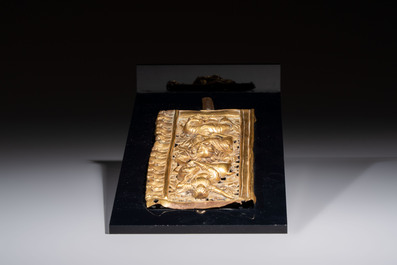 A fine Tibetan gilt-copper repouss&eacute; plaque depicting a Dharmapala, a lion and an elephant, on a later mount, 18th C.