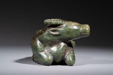A Chinese green jade reclining buffalo on a wooden stand, 19/20th C.
