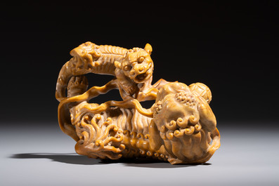 A fine Chinese soapstone group of Buddhist lions on wooden stand, 19th C.