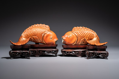 A pair of Chinese coral-red-glazed gilt-decorated 'Goldfish' wall pocket vases on wooden stands, Republic