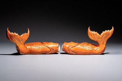 A pair of Chinese coral-red-glazed gilt-decorated 'Goldfish' wall pocket vases on wooden stands, Republic