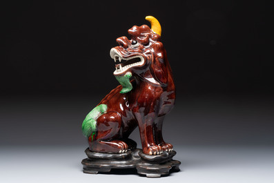A Chinese sancai-glazed Xiezhi on a wooden stand, 19th C.