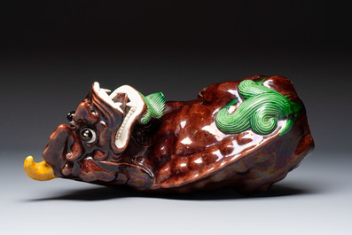 A Chinese sancai-glazed Xiezhi on a wooden stand, 19th C.