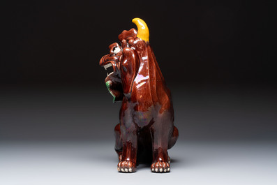 A Chinese sancai-glazed Xiezhi on a wooden stand, 19th C.