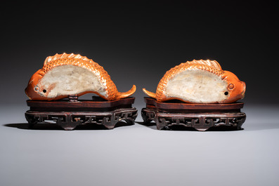 A pair of Chinese coral-red-glazed gilt-decorated 'Goldfish' wall pocket vases on wooden stands, Republic