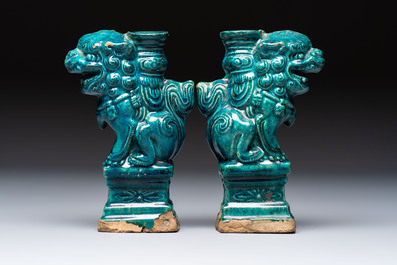 A pair of Chinese turquoise-glazed lion-shaped joss stick holders on wooden stands, Ming
