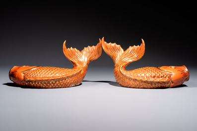 A pair of Chinese coral-red-glazed gilt-decorated 'Goldfish' wall pocket vases on wooden stands, Republic