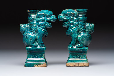 A pair of Chinese turquoise-glazed lion-shaped joss stick holders on wooden stands, Ming