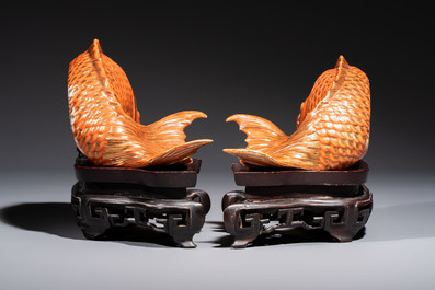 A pair of Chinese coral-red-glazed gilt-decorated 'Goldfish' wall pocket vases on wooden stands, Republic