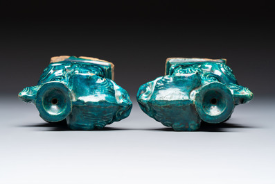 A pair of Chinese turquoise-glazed lion-shaped joss stick holders on wooden stands, Ming