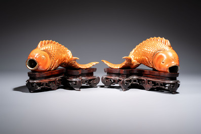 A pair of Chinese coral-red-glazed gilt-decorated 'Goldfish' wall pocket vases on wooden stands, Republic