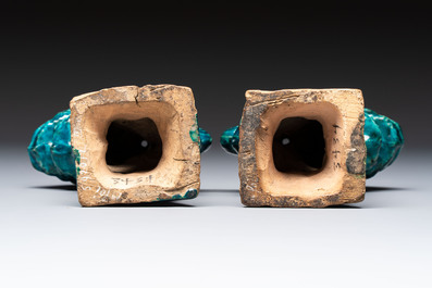 A pair of Chinese turquoise-glazed lion-shaped joss stick holders on wooden stands, Ming