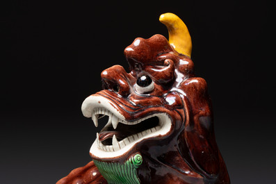 A Chinese sancai-glazed Xiezhi on a wooden stand, 19th C.
