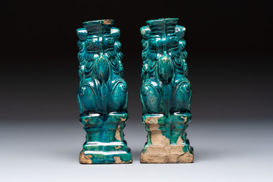 A pair of Chinese turquoise-glazed lion-shaped joss stick holders on wooden stands, Ming