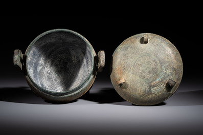 A Chinese archaic bronze tripod food vessel and cover, Ding 鼎, Eastern Zhou