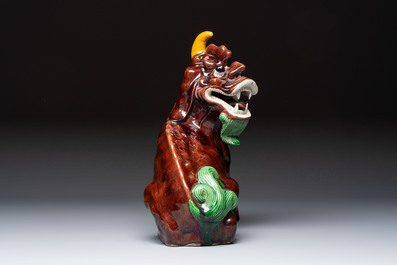 A Chinese sancai-glazed Xiezhi on a wooden stand, 19th C.
