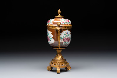 A pair of gilt-bronze-mounted Chinese famille rose capucine-ground vases and a covered bowl, Qianlong