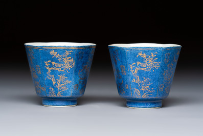 A pair of Chinese gilt-decorated powder-blue-ground 'Antiquities' cups and saucers, lingzhi mark, Kangxi