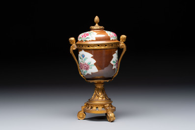 A pair of gilt-bronze-mounted Chinese famille rose capucine-ground vases and a covered bowl, Qianlong