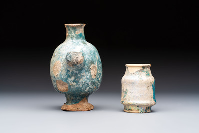 A small turquoise-glazed albarello and three oil lamps, Iran or Syria, 12/13th C.
