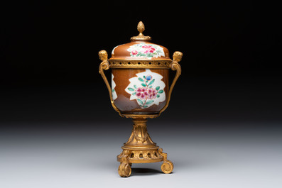 A pair of gilt-bronze-mounted Chinese famille rose capucine-ground vases and a covered bowl, Qianlong