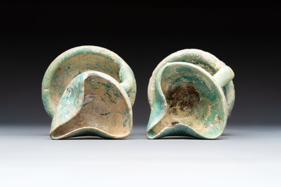 A small turquoise-glazed albarello and three oil lamps, Iran or Syria, 12/13th C.