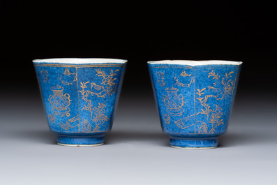 A pair of Chinese gilt-decorated powder-blue-ground 'Antiquities' cups and saucers, lingzhi mark, Kangxi