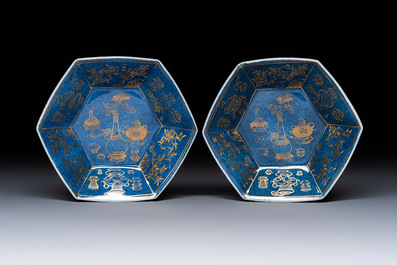 A pair of Chinese gilt-decorated powder-blue-ground 'Antiquities' cups and saucers, lingzhi mark, Kangxi