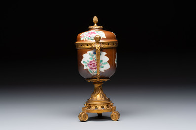 A pair of gilt-bronze-mounted Chinese famille rose capucine-ground vases and a covered bowl, Qianlong