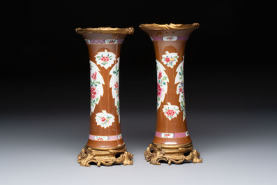 A pair of gilt-bronze-mounted Chinese famille rose capucine-ground vases and a covered bowl, Qianlong