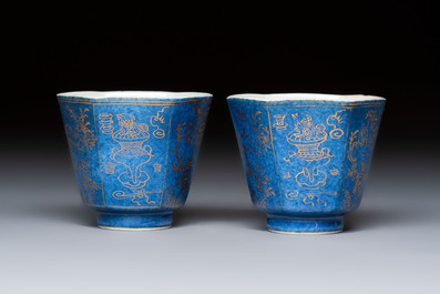 A pair of Chinese gilt-decorated powder-blue-ground 'Antiquities' cups and saucers, lingzhi mark, Kangxi