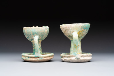A small turquoise-glazed albarello and three oil lamps, Iran or Syria, 12/13th C.