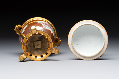 A pair of gilt-bronze-mounted Chinese famille rose capucine-ground vases and a covered bowl, Qianlong