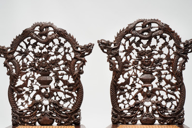 A pair of richly carved Chinese hongmu 'Dragon' chairs with cane seats, 19th C.