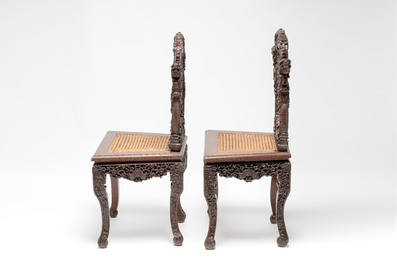 A pair of richly carved Chinese hongmu 'Dragon' chairs with cane seats, 19th C.
