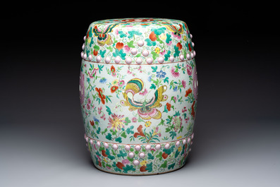 A Chinese famille rose garden seat with butterflies, flowers and fruiting branches, 19th C.