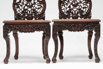 A pair of richly carved Chinese hongmu 'Dragon' chairs with cane seats, 19th C.