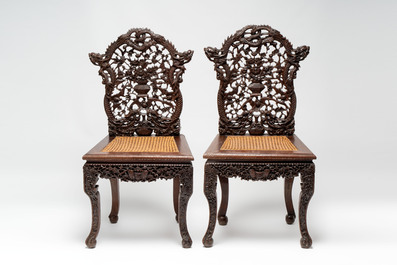 A pair of richly carved Chinese hongmu 'Dragon' chairs with cane seats, 19th C.