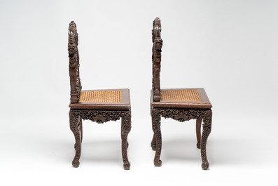 A pair of richly carved Chinese hongmu 'Dragon' chairs with cane seats, 19th C.